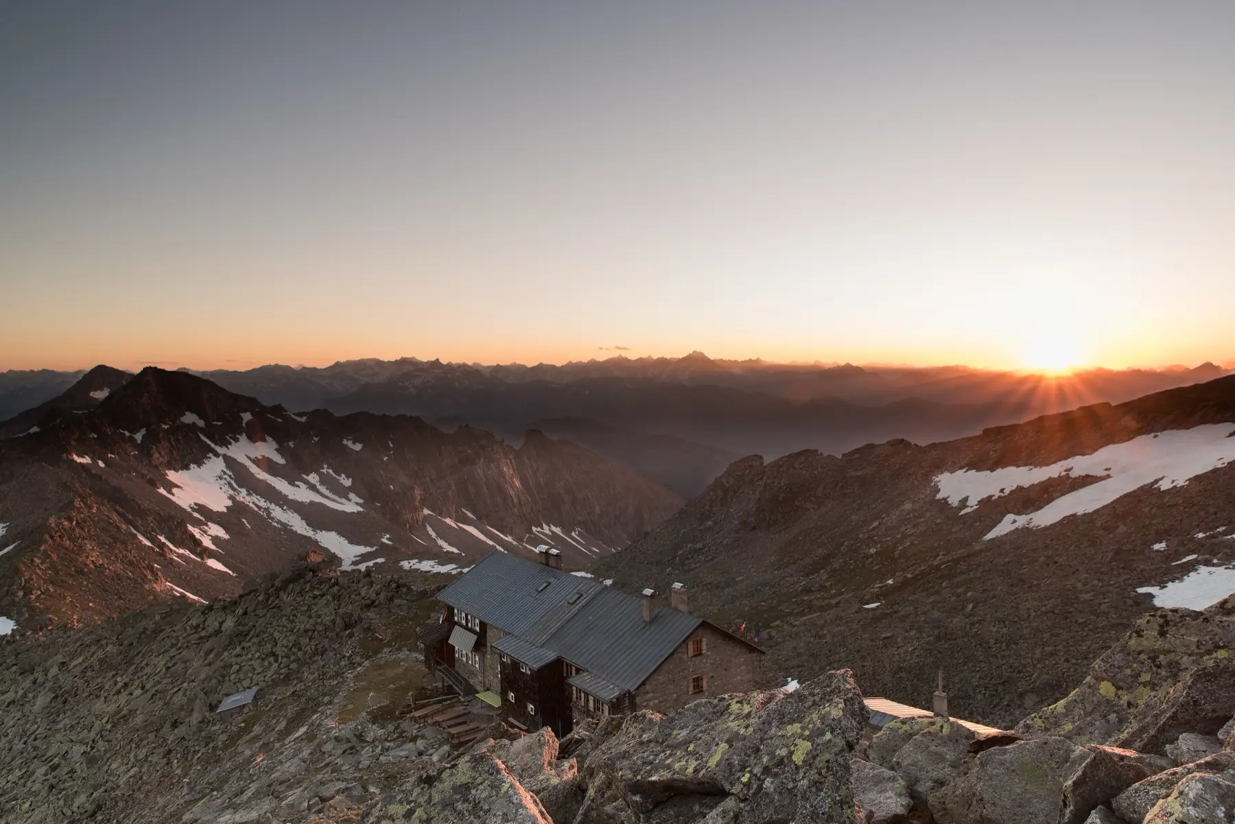 A mountain hut perched on a high rocky ridge