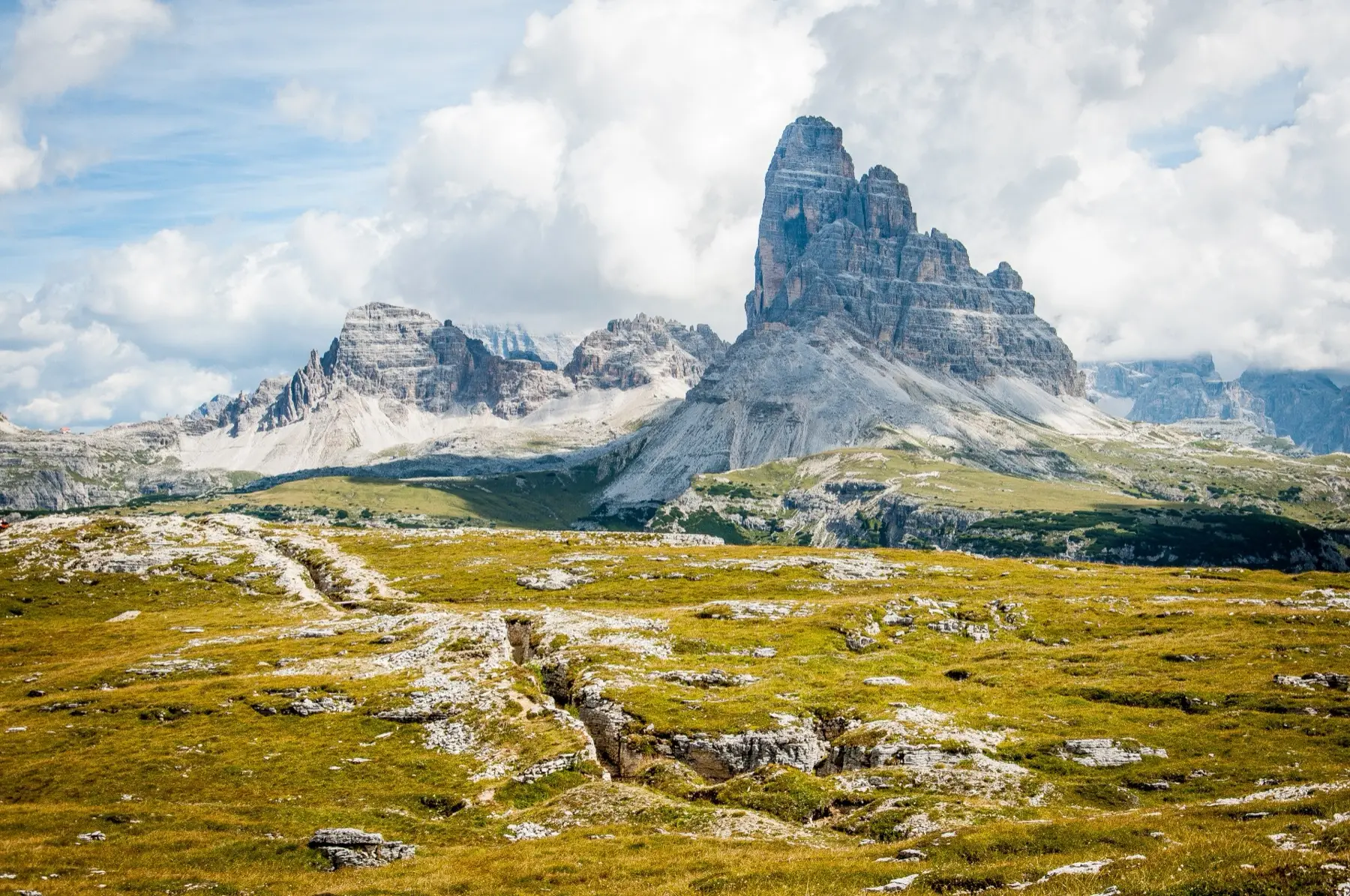 Monte Piana meadows with a path leading toward the Sexten Dolomites