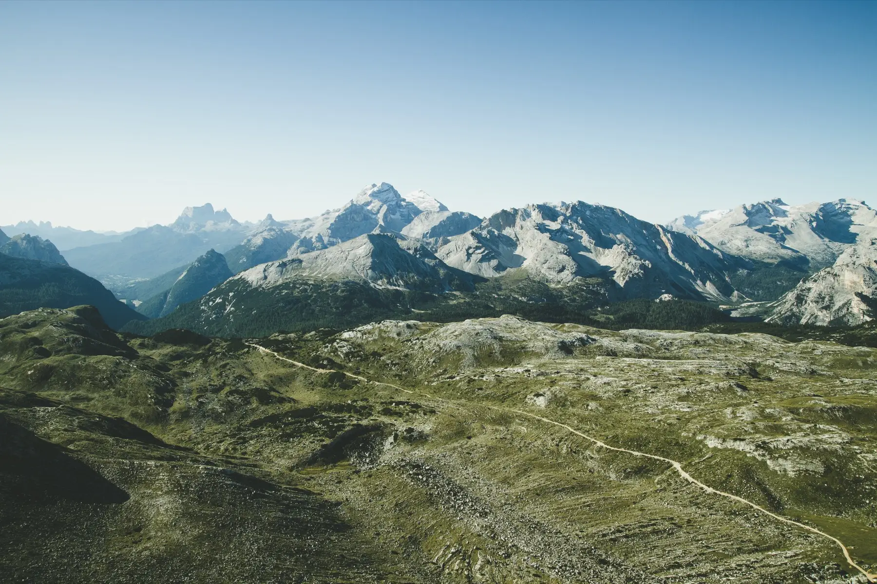 Rifugio Biella, a stone hut on a high, bare limestone plateau under a clear sky